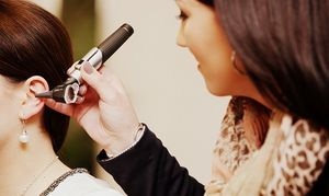 Ärztin untersucht das Ohr einer Patientin mit Otoskop bei einer Ohrenuntersuchung.